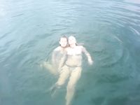 Curvy adult bares all at a nudist beach in the sun