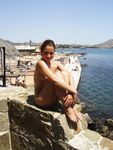 A Sun-Kissed Nude Sunbather With Sand on Her Feet