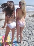 Slim girl with perky boobs naked at a nudist beach