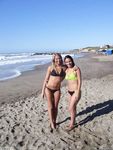 Slim girl with perky boobs naked at a nudist beach