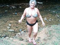 Gorgeous wet adult naturist plays in the water
