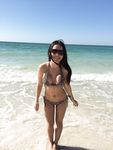 Relaxed and Seated on the Nude Beach in Sunglasses