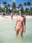 Relaxed and Seated on the Nude Beach in Sunglasses