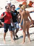 An Easy Stroll for Three Nudists Along Sandy Shoreline