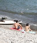 Heating up the beach by exposing her nude figure