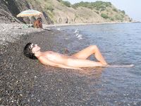 Heating up the beach by exposing her nude figure