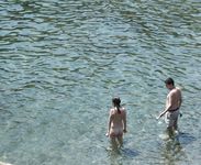 Heating up the beach by exposing her nude figure