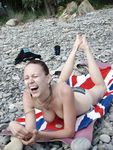 Heating up the beach by exposing her nude figure