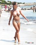 Curvy Topless Woman On A Beach
