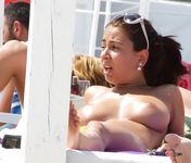 Topless ebony adult on the beach
