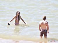 horny girl topless on the beach