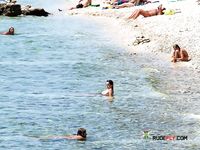 horny girl topless on the beach