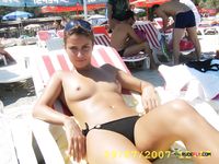 horny girl topless on the beach