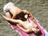 Two Naturists Posing Together on a Rocky Riverbank