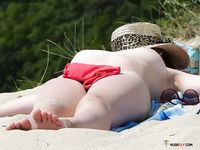 Tree-Lined Nude Beach with a Redhead Seated on Sand