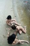 Sitting at the Waterline with Three Nudists on Wet Sand