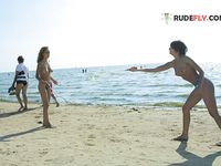 Wading Together at a Tree-Lined Naturist Lake Shore