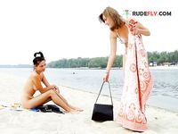 Wading Together at a Tree-Lined Naturist Lake Shore