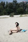 Leaning Back on a Towel at a Nude Beach Riverbank