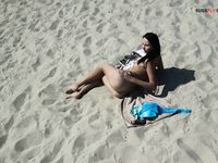 Leaning Back on a Towel at a Nude Beach Riverbank