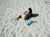 Leaning Back on a Towel at a Nude Beach Riverbank
