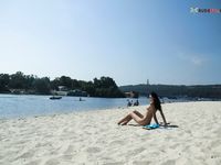 Leaning Back on a Towel at a Nude Beach Riverbank