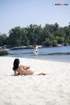 Leaning Back on a Towel at a Nude Beach Riverbank