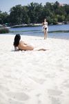 Leaning Back on a Towel at a Nude Beach Riverbank