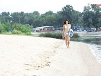Tracing Patterns in Wet Sand Beside a Calm River