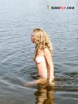 Topless Sunbathing on Open Sand With Natural Scenery Around