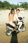 White Bikini Bottoms and Crossed Arms on a Sandy Topless Beach