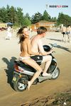 White Bikini Bottoms and Crossed Arms on a Sandy Topless Beach