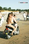 White Bikini Bottoms and Crossed Arms on a Sandy Topless Beach