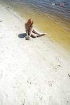Green Beads and Wet Sand While Building a Sandcastle