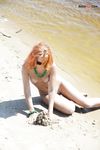 Green Beads and Wet Sand While Building a Sandcastle