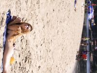 Green Beads and Wet Sand While Building a Sandcastle