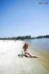 Green Beads and Wet Sand While Building a Sandcastle