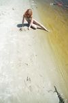 Green Beads and Wet Sand While Building a Sandcastle