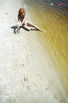 Green Beads and Wet Sand While Building a Sandcastle