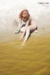 Green Beads and Wet Sand While Building a Sandcastle
