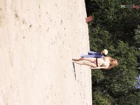 Green Beads and Wet Sand While Building a Sandcastle