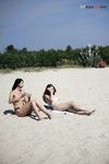 A Tender Kiss Between Two Women on a Quiet Nude Beach