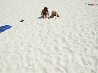 Damp Hair and Kneeling Sand on a Bright Nude Beach Dune