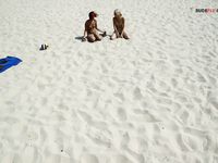 Damp Hair and Kneeling Sand on a Bright Nude Beach Dune