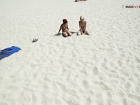 Damp Hair and Kneeling Sand on a Bright Nude Beach Dune