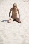 Damp Hair and Kneeling Sand on a Bright Nude Beach Dune