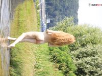 Topless by the Lake Shore in a Green Bead Necklace