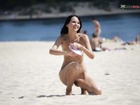 toying with her honeypot on a public strand