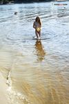 River Shallows Hold Three Nude Friends Under Summer Sun