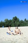 River Shallows Hold Three Nude Friends Under Summer Sun